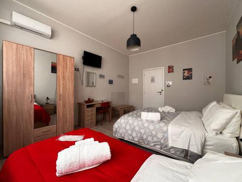 カターニアにあるCatina Domusのベッドルーム1室(ベッド2台、赤毛布付)