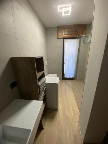 a small room with a sink and a toilet at Mountain Apartments Tarvisio in Tarvisio