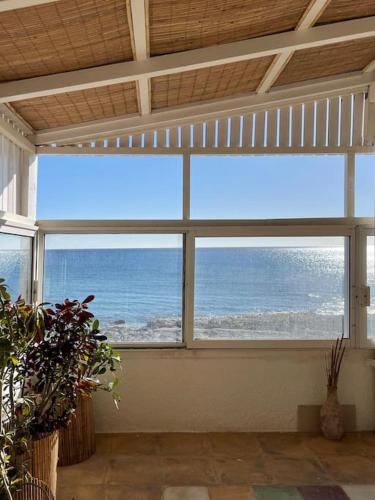 a room with a large window with a view of the ocean at VistaMare2 Double room-sea view in Koutsourás