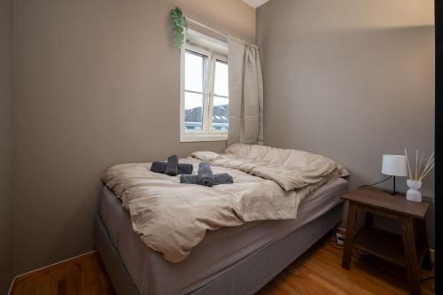 a bed in a room with a window at Studio apt in city centre in Trondheim