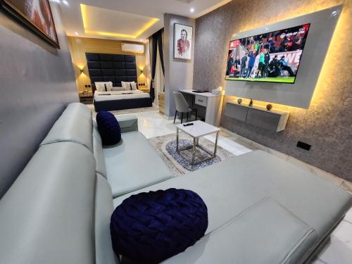 a living room with a couch and a tv at Atlantic Palms Suites in Lekki
