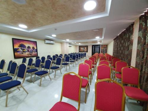a room with rows of chairs with blue and red chairs at Atlantic Palms Suites in Lekki