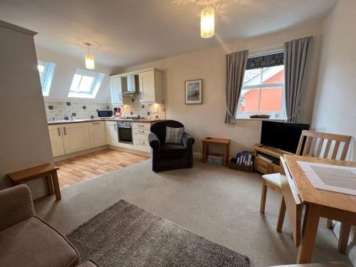 a living room with a couch and a table at Central Village flat, close to beach in Milford on Sea