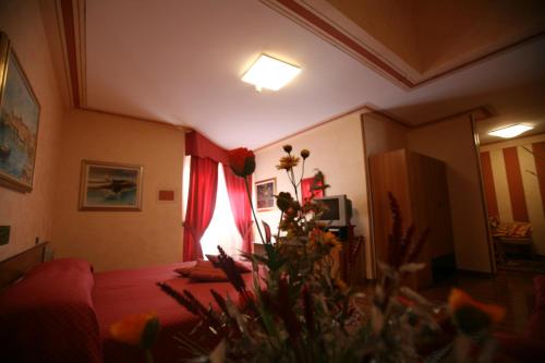 a living room with a bed and a window at Hotel La Ruota in Pianfei