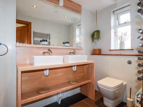 a bathroom with two sinks and a toilet at Sea View House in Newquay