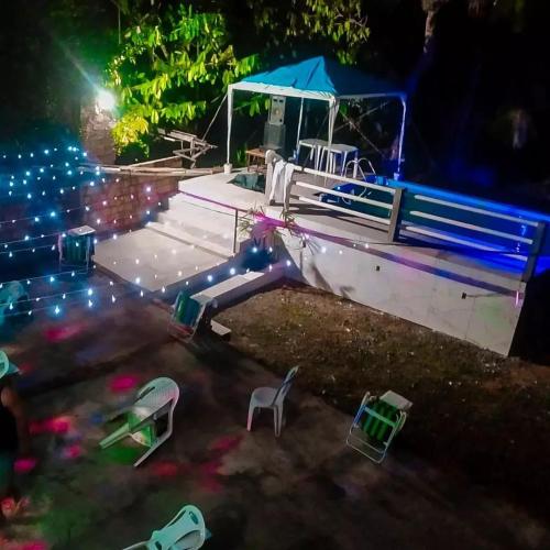 a boat with chairs and lights at night at Casa ariramba Mosqueiro in Belém