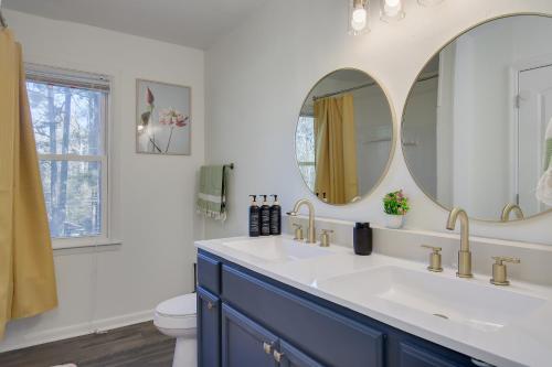 a bathroom with a sink and two mirrors at 15mins AU & Golf: 4bd - Eclectic - BBQ Grill in Augusta