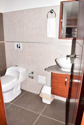 a bathroom with a toilet and a sink at Apartaestudio Loft 203 - UE Home in Duitama