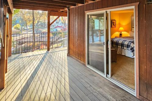 a room with a balcony with a bed and a door at Heart's Desire on the Lake (01-275) in Groveland