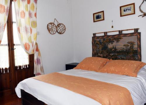 エラティ・トリカラにあるΛΑΓΟΥΜΙ suite Α1のベッドルーム1室(オレンジ色の掛け布団付きのベッド1台付)