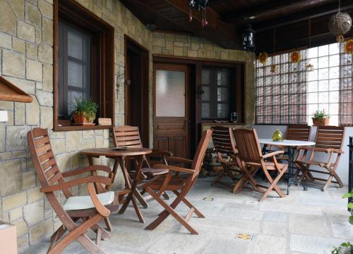 a group of chairs and tables on a patio at ΛΑΓΟΥΜΙ suite Α1 in Elati Trikalon