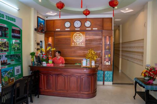 a woman standing behind a counter in a restaurant at Hoian Old Town Hostel in Hoi An