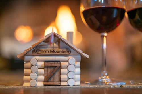 a small house with a candle and a glass of wine at Storm Mountain Lodge & Cabins in Banff