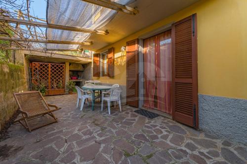 a patio with a table and chairs on it at Appartamenti La Marina - Goelba in Marciana Marina