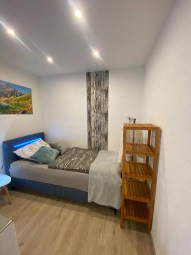 a bedroom with a bed and a book shelf at Ferienwohnung Bergruhe in Memmingen