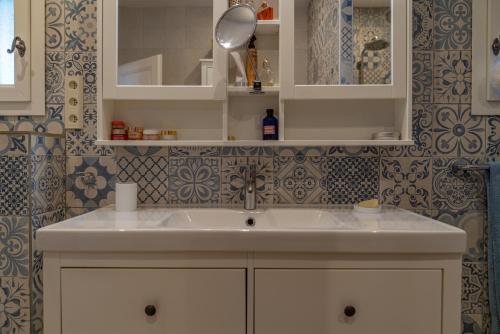 a bathroom with a sink and a mirror at Rosa - Sublime villa piscine avec vue et pinèdes in Saint-Georges-dʼOrques
