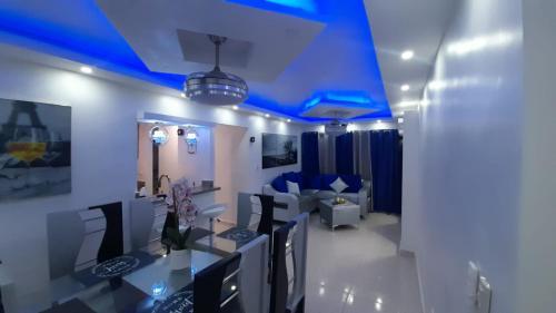 a dining room with blue lighting and a table and chairs at Palmer in Santiago de los Caballeros