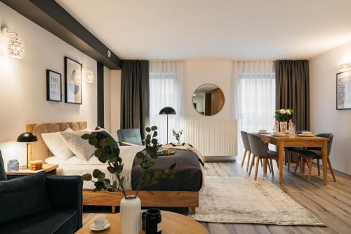 a living room with a couch and a table at ORSO Rooms & Apartments - LoftAffair Collection in Warsaw