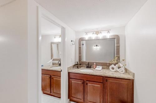 a bathroom with a sink and a mirror at 306 Sandcastles in Fernandina Beach