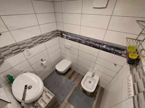 a small bathroom with a toilet and a sink at Tiha dolina in Železniki