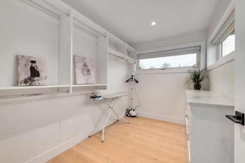 a white room with a desk and a window at Villa Z in Vancouver