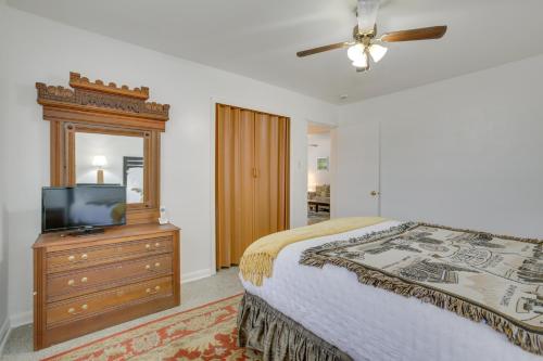 a bedroom with a bed and a television on a dresser at New Orleans Area Home about 5 Mi to City Park! in Metairie
