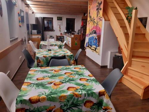 a dining room with a table and chairs and a staircase at Odal Hawaii sro ubytování vzdělávání in Pěnčín