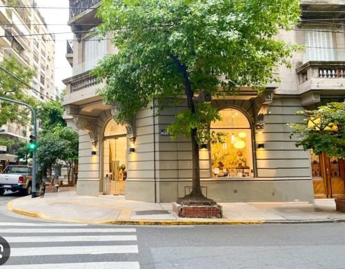 a tree in front of a building on a street at Pleno Recoleta in Buenos Aires