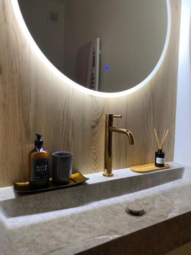 a bathroom counter with a sink with a mirror at Apartmán TOMI in Brezno