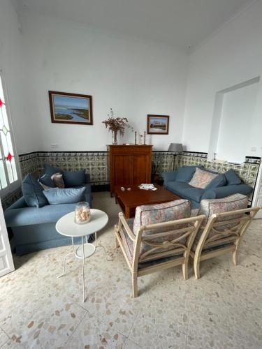 a living room with a couch and a table at HOSTAL LA CRUZ 1872 in Chipiona