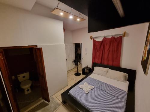a bedroom with a bed and a red curtain at The Wabi Sabi in León