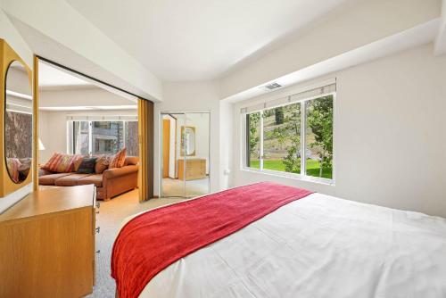 One Bedroom #202 في وادي اولومبيك: غرفة نوم بسرير كبير وأريكة