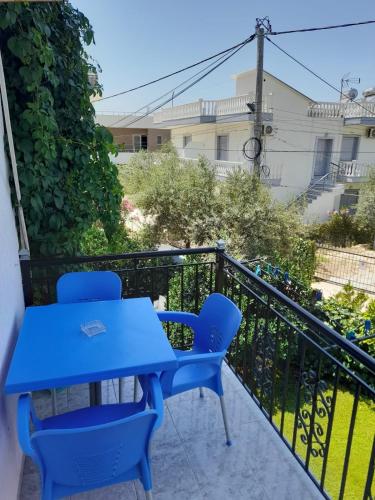 a blue table and chairs on a balcony at Villa Festim Ksamil in Ksamil
