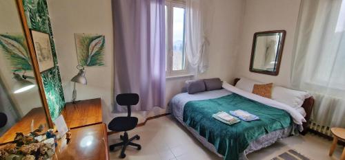 a small bedroom with a bed and a mirror at Monstera room Vicino al centro in Perugia