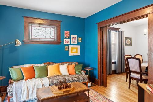 a living room with blue walls and a couch at Beautiful Victorian Home Located Downtown Moncton in Moncton