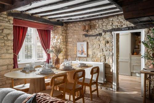 a dining room with a table and chairs at Bourton Scandi Chic Authentic Cottage in Bourton on the Water