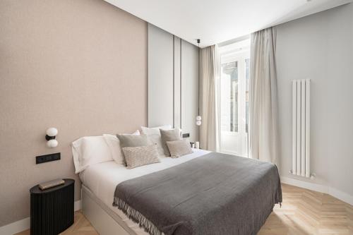 a bedroom with a large bed and a window at Luxury flat Centro XVI in Madrid