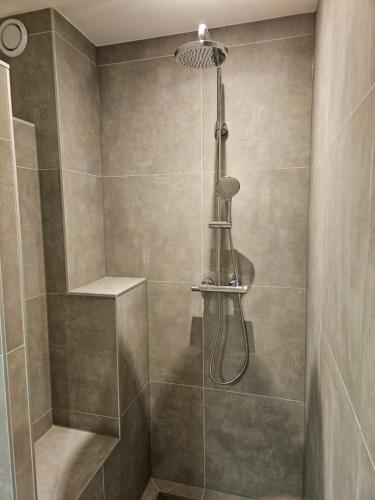 a bathroom with a shower with a shower head at Tuinen van Genta - Breda City in Breda