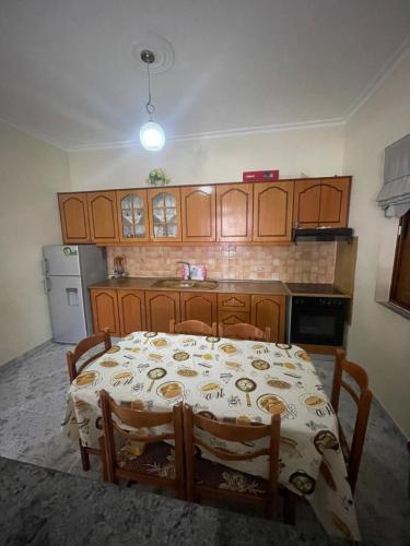 a kitchen with a table in the middle of it at Villa Festim Ksamil in Ksamil