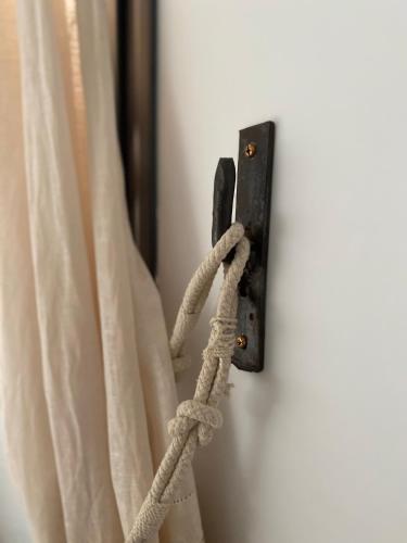 a hook with a rope attached to a curtain at Lavender farm house in Nafpaktos