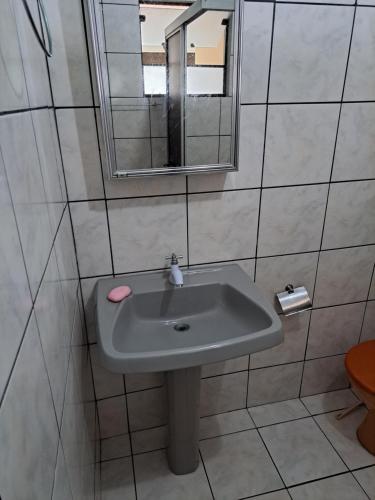 a bathroom with a sink and a mirror at Aconchego no litoral in Barra Velha