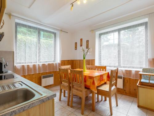 a kitchen with a table with chairs and a sink at Holiday Home Malovidy by Interhome in Rataje nad Sázavou