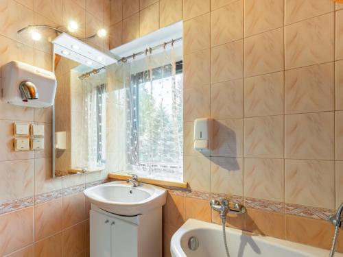 a bathroom with a sink and a toilet and a window at Holiday Home Malovidy by Interhome in Rataje nad Sázavou