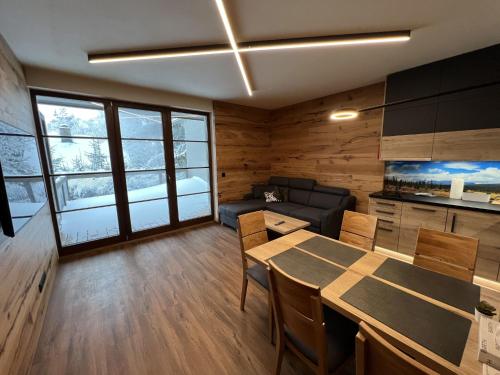 a living room with a table and a couch at Apartment Říčky v Orlických horách C21 by Interhome in Říčky