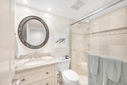 a bathroom with a shower and a toilet and a sink at Breath-taking waterfront condo with pool/spa/tennis in Marco Island
