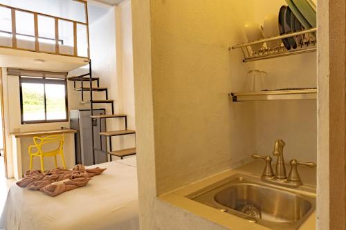 a kitchen with a sink in a room at Hotel Pura Natura Riverside Tortuguero in Tortuguero