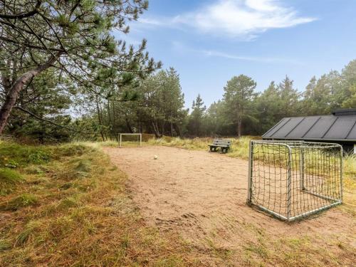 a goal in the dirt with a bench in a field at Holiday Home Emila - 2-2km from the sea in Western Jutland by Interhome in Bolilmark