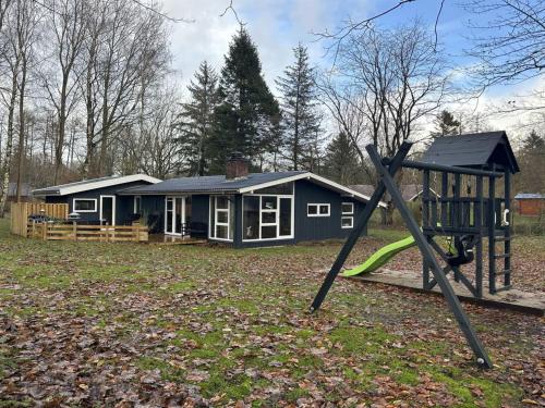 a playground in front of a house at Holiday Home Gretl in Western Jutland by Interhome in Arrild