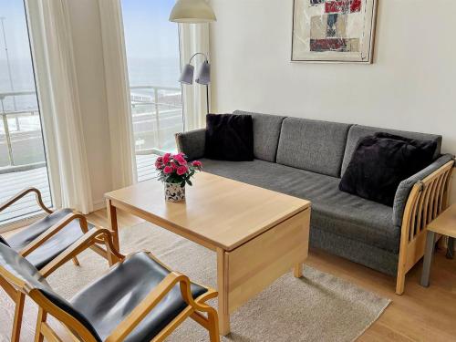 a living room with a couch and a table at Apartment Henna - 50m from the sea in Bornholm by Interhome in Allinge