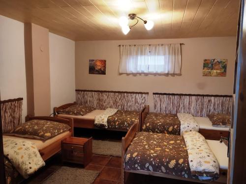 Habitación con 4 camas y ventana en Chalupa Majer Biffar, en Dunajský Klátov